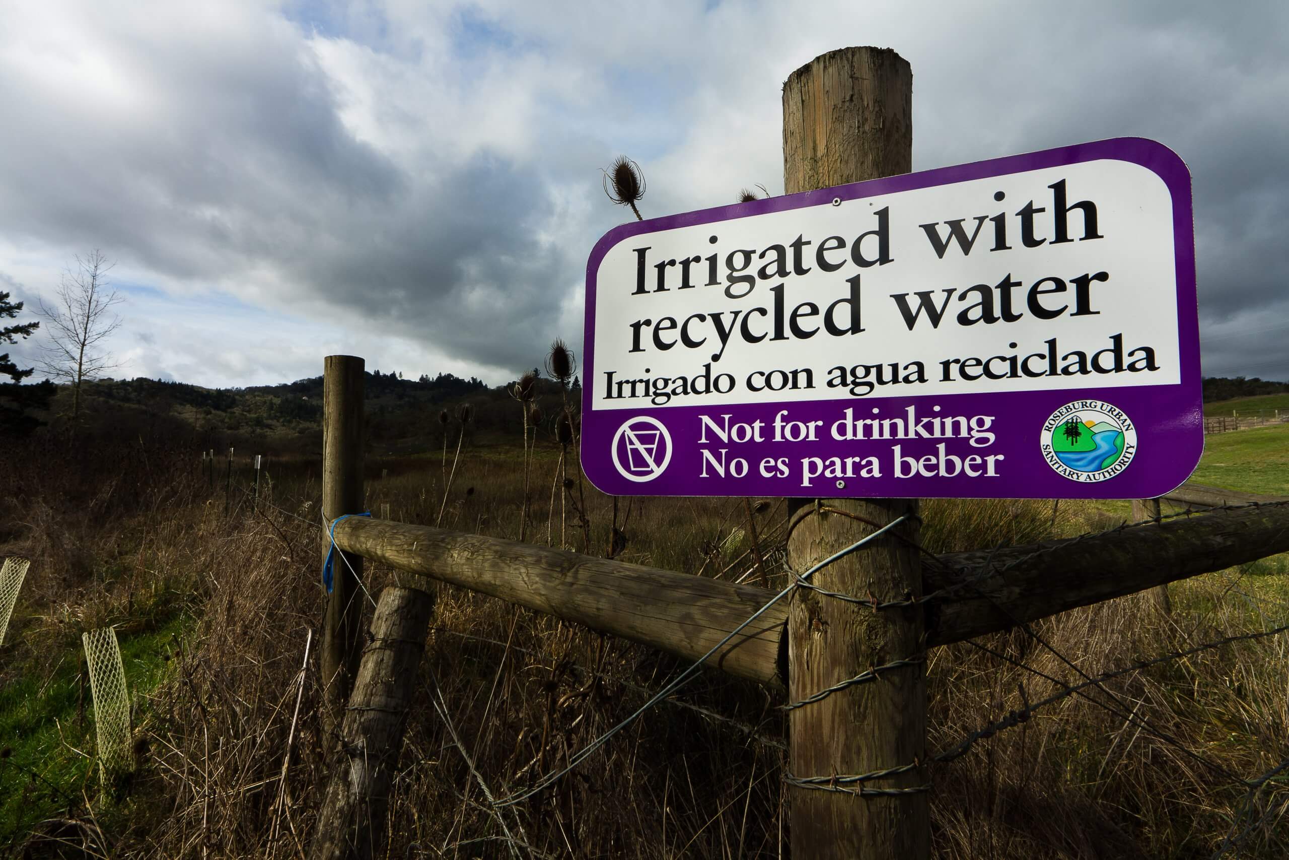 Sign on fence post reading, "Irrigated with recycled water".