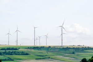 Windmills over green terrain