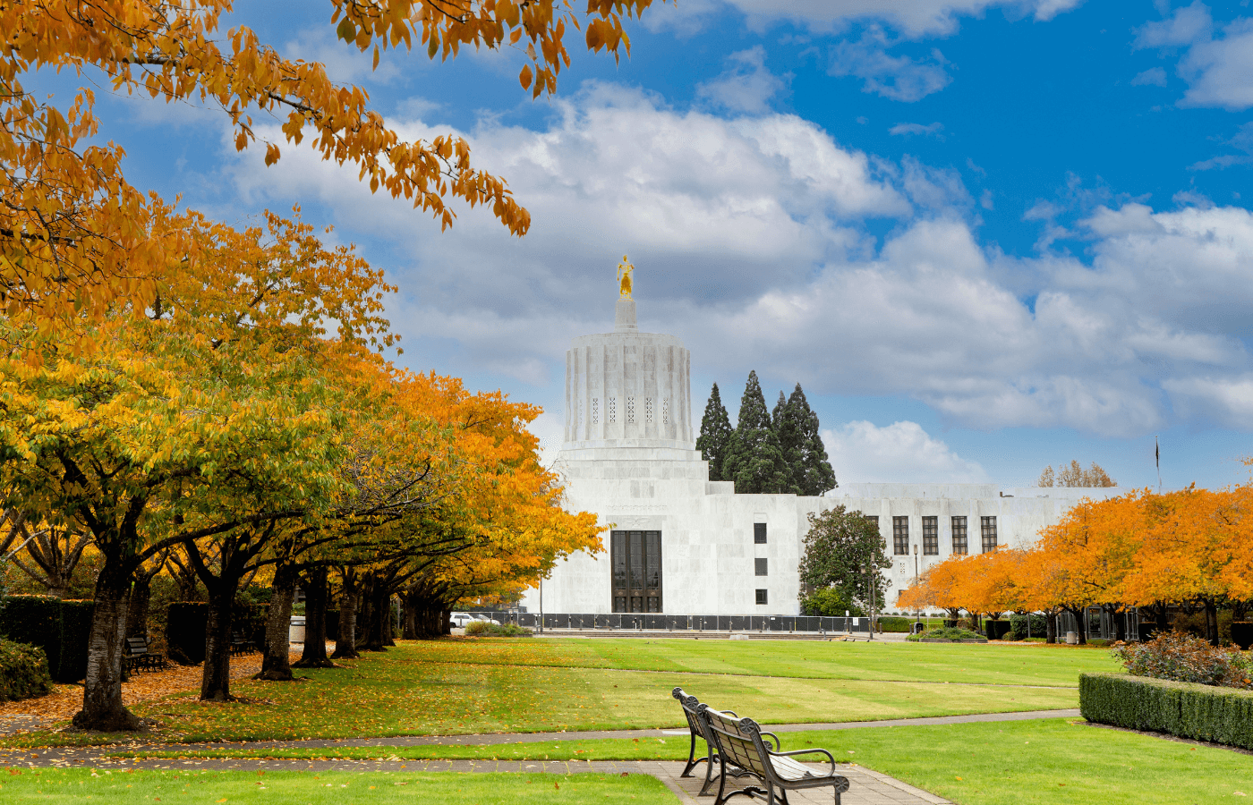 oregon state capitol building in salem in fall with orange leaves on the trees