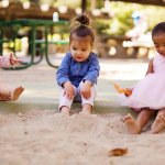 Three kids playing in a sandbox